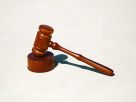Wooden gavel on a flat surface